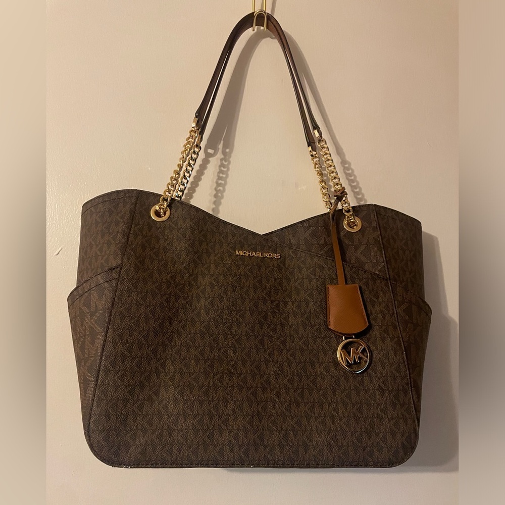 Micheal Kors worn once hand bag . Brown and tan with straps with gold chains